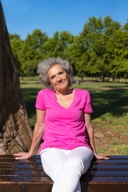 istock Confident old lady relaxing in park 1170698428