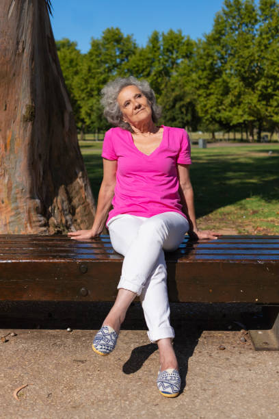 istock Pensive tranquil old lady dreaming in park 1170698915