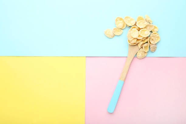 istock Corn flakes in wooden spoon on colorful background 1170700290
