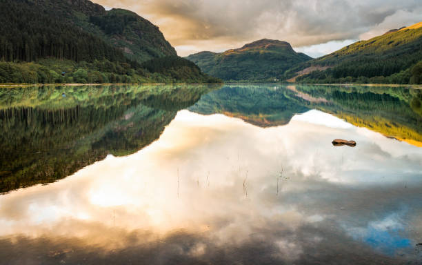 Loch Lubnaig in the Scottish Trossachs Calm water reflecting the mountains and cloudscape above Loch Lubnaig in Scotland. calm water stock pictures, royalty-free photos & images
