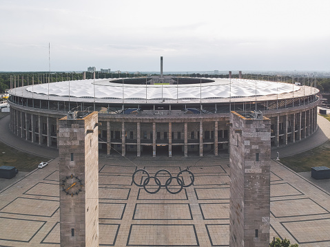 Berlin / Germany - July 2019: Summer flight over Olympiastadion, a sports stadium at Olympiapark in Berlin. It was originally built by Werner March for the 1936 Summer Olympics