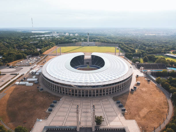 Berlin Berlin / Germany - July 2019: Summer flight over Olympiastadion, a sports stadium at Olympiapark in Berlin. It was originally built by Werner March for the 1936 Summer Olympics international match stock pictures, royalty-free photos & images