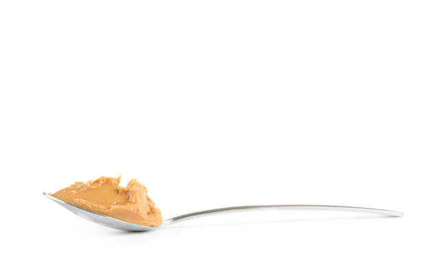 istock Peanut butter in spoon isolated on white background 1170704335