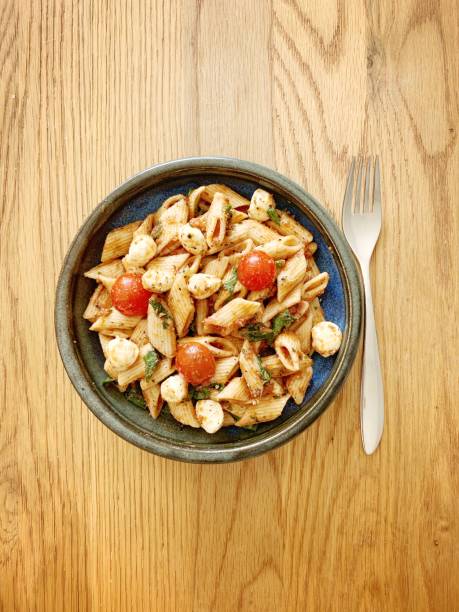 istock Vegetarian pasta with cherry tomato, mozzarella, spinach and basil 1170704380