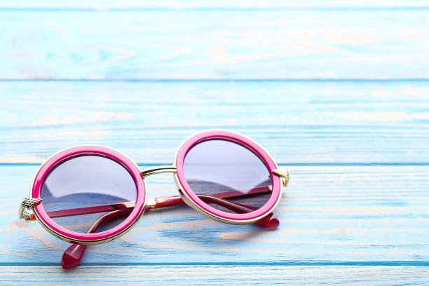 istock Modern sunglasses on blue wooden table 1170706892