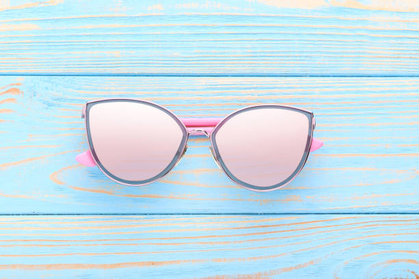 istock Modern sunglasses on blue wooden table 1170707131