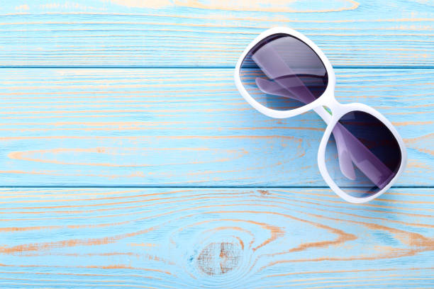 istock Modern sunglasses on blue wooden table 1170707577