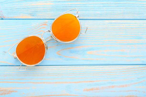 istock Modern sunglasses on blue wooden table 1170708896