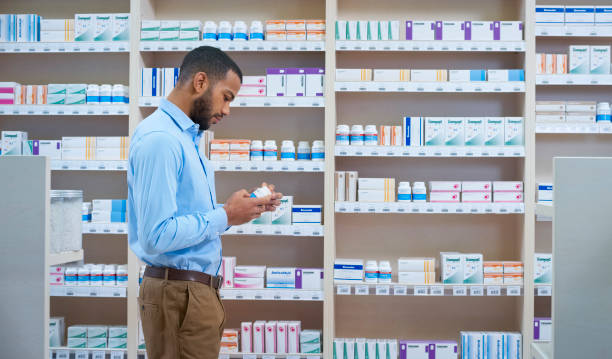 istock Man reading label of medicine bottle 1170709333