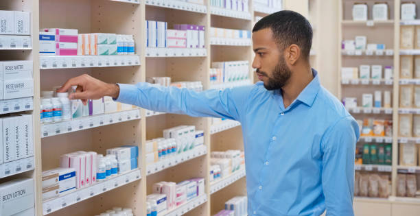 istock Man reading label of medicine bottle 1170709340