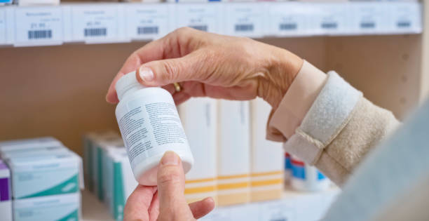 istock Woman's hand holding medicine bottle 1170709358