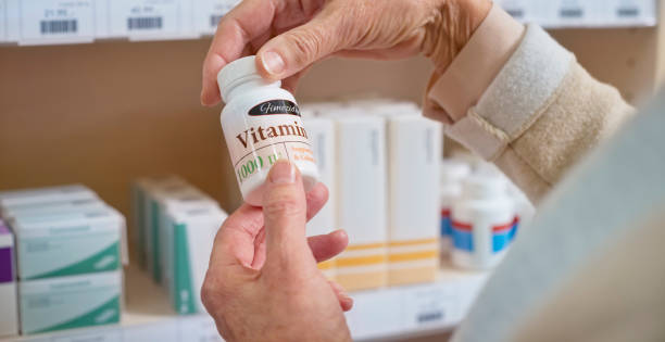 istock Woman's hand holding medicine bottle 1170709361