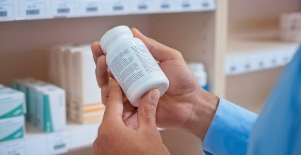 istock Man's hand holding medicine bottle 1170709363