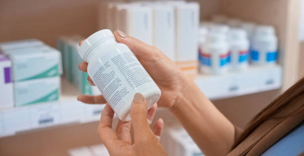 istock Woman's hand holding medicine bottle 1170709385