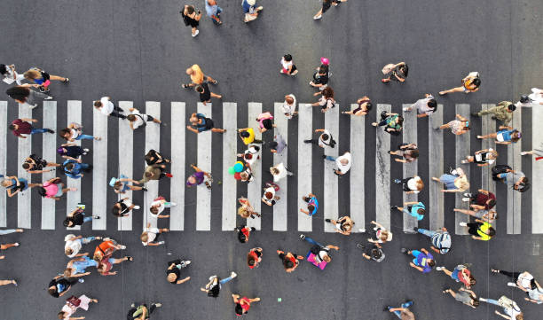 istock Aerial. People crowd on pedestrian crosswalk. Top view from drone. 1170710329