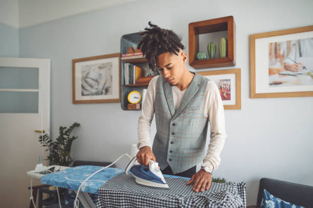 istock Young man ironing his shirt 1170710820