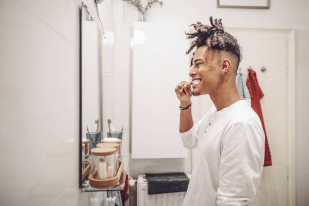 istock At home - young man brushing his teeth 1170713262