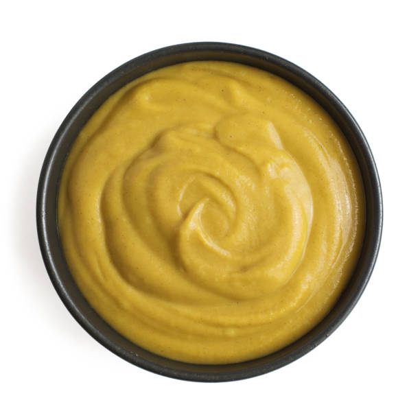 istock Mustard sauce in dark ceramic bowl isolated on white background. Top view 1170713269