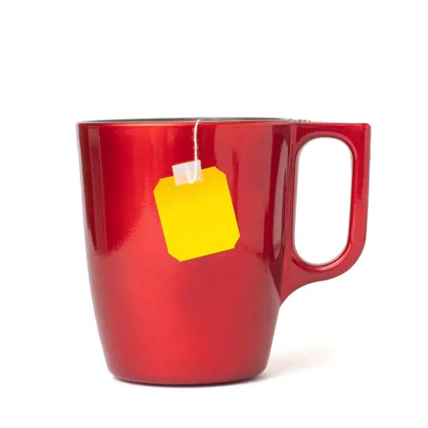 Photo of Tea bag in red cup isolated on white background