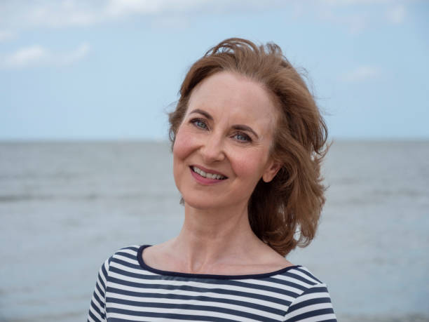 istock Serious mature woman at beach. 1170713828