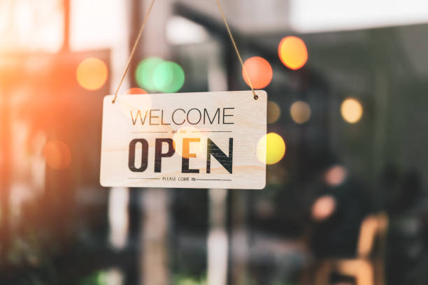 istock Open sign hanging front of cafe with colorful bokeh light abstract background. 1170713880