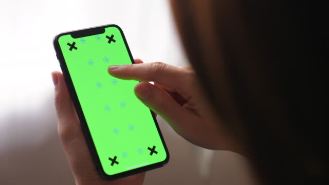 Young woman using phone,Green screen
