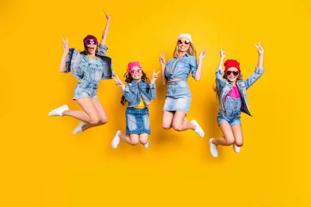 Summer time concept. Full length photo of four excited crazy funny funky, trendy making giving t-sign wearing streetstyle denim apparel skirt overall having good mood isolated bright yellow background