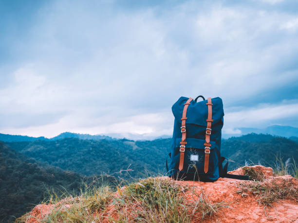 istock camping and travel in tropical forest concept from big blue backpack put on floor with soft focus mountain and copy space background 1170715826