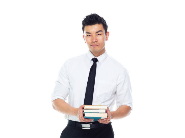 istock Handsome Asian Businessman - is holding books 1170718736