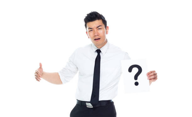 istock Handsome Asian Businessman - is holding a question mark sign 1170718798