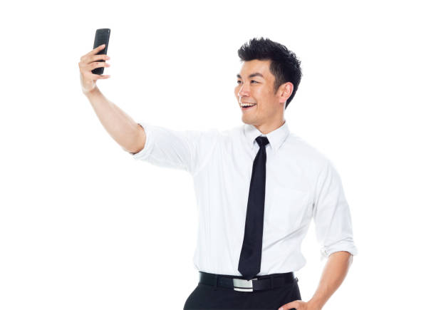 istock Handsome Asian Businessman - is taking selfie 1170718804