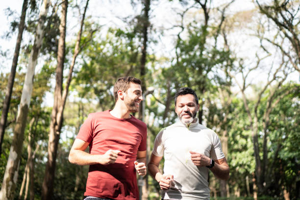 istock Friends running together in a park 1170719154