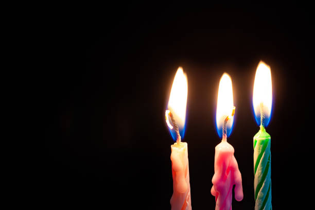 istock Three birthday candles on black background detail art 1170720510