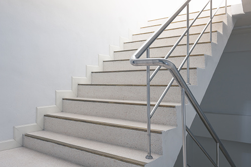 Side view of metal stairs and blue sky.