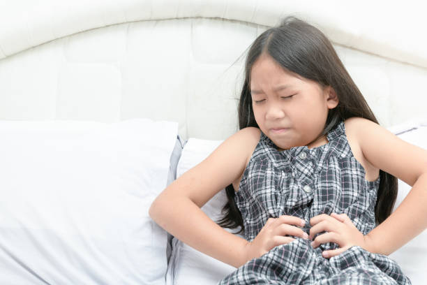 istock asian girl suffering from stomachache 1170722068