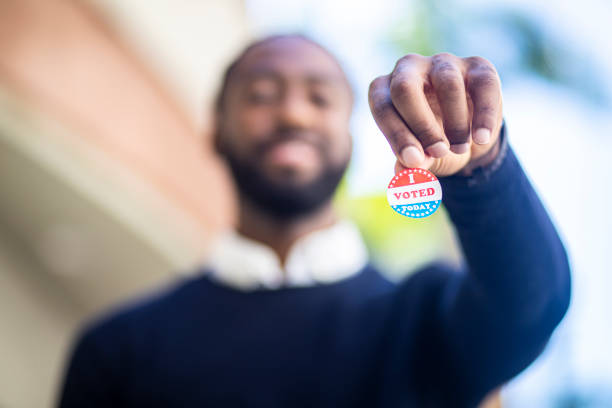 young black man with i voted sticker - jovens a votar imagens e fotografias de stock