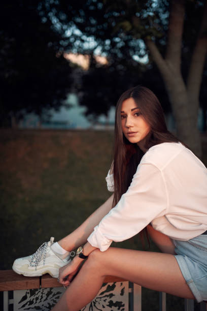 istock Beautiful young brunette in a summer park 1170722797