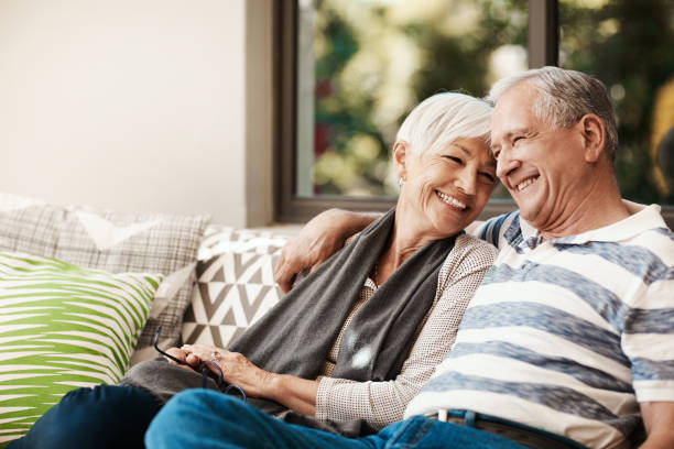 Never stop loving each other Shot of a happy senior couple relaxing together on a sofa outside at home porch stock pictures, royalty-free photos & images