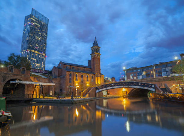 Castlefield Blue hour in Manchester, Great Britain. Castlefield  at Deansgate on the Bridgewater Canal in Manchester. blue hour twilight photos stock pictures, royalty-free photos & images