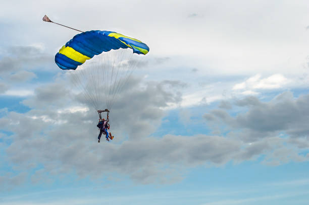 istock Paraglider tandem fly against the blue sky. 1170726094