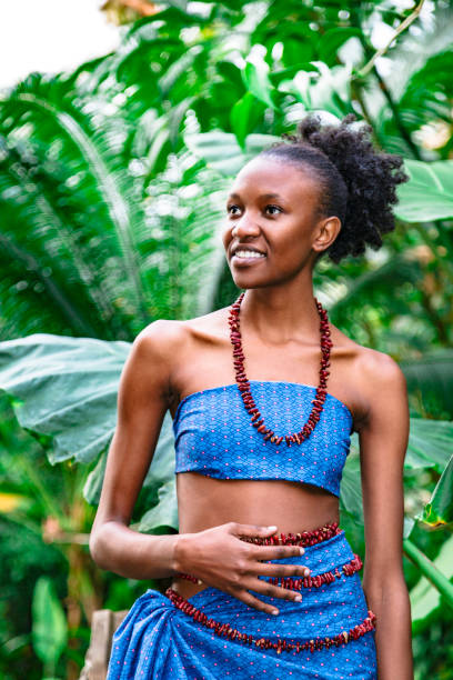 fille africaine dans l'habillement national dans la jungle verte - nigeria african culture dress smiling photos et images de collection