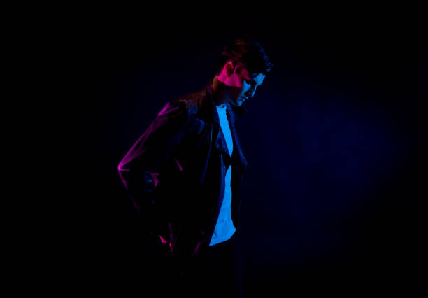 istock Good looking man wearing a leather jacket in front of black background 1170727312