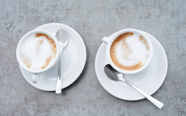 istock Two cups of cappuccino on a textured grey background. Close-up. 1170727350