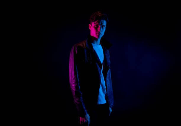 istock Good looking man wearing a leather jacket in front of black background 1170728246