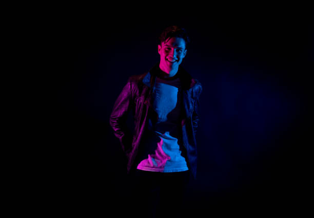 istock Good looking man wearing a leather jacket in front of black background 1170728271