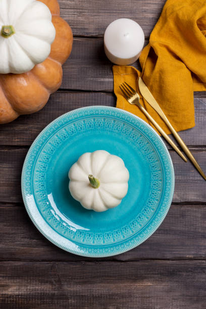 istock Empty serving plate with pumpkin, tableware and napkin on wood background 1170728467