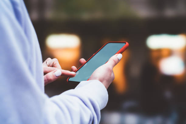 istock Cropped view of woman's hands holding modern smartphone device with big copy space screen. Female hands holding modern cellular outdoors. Social network content, internet traffic data. Free wi 1170728863