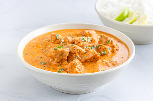 Indian Butter Chicken with Rice, Creamy Indian Chicken Curry DIsh, White Background, Indian Food Photography.