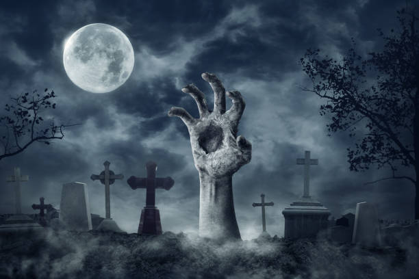 istock Zombie Hand Rising Out Of A Graveyard In Spooky Night 1170731631