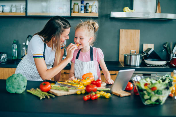 istock Mother and daughter making healthy meal 1170731974